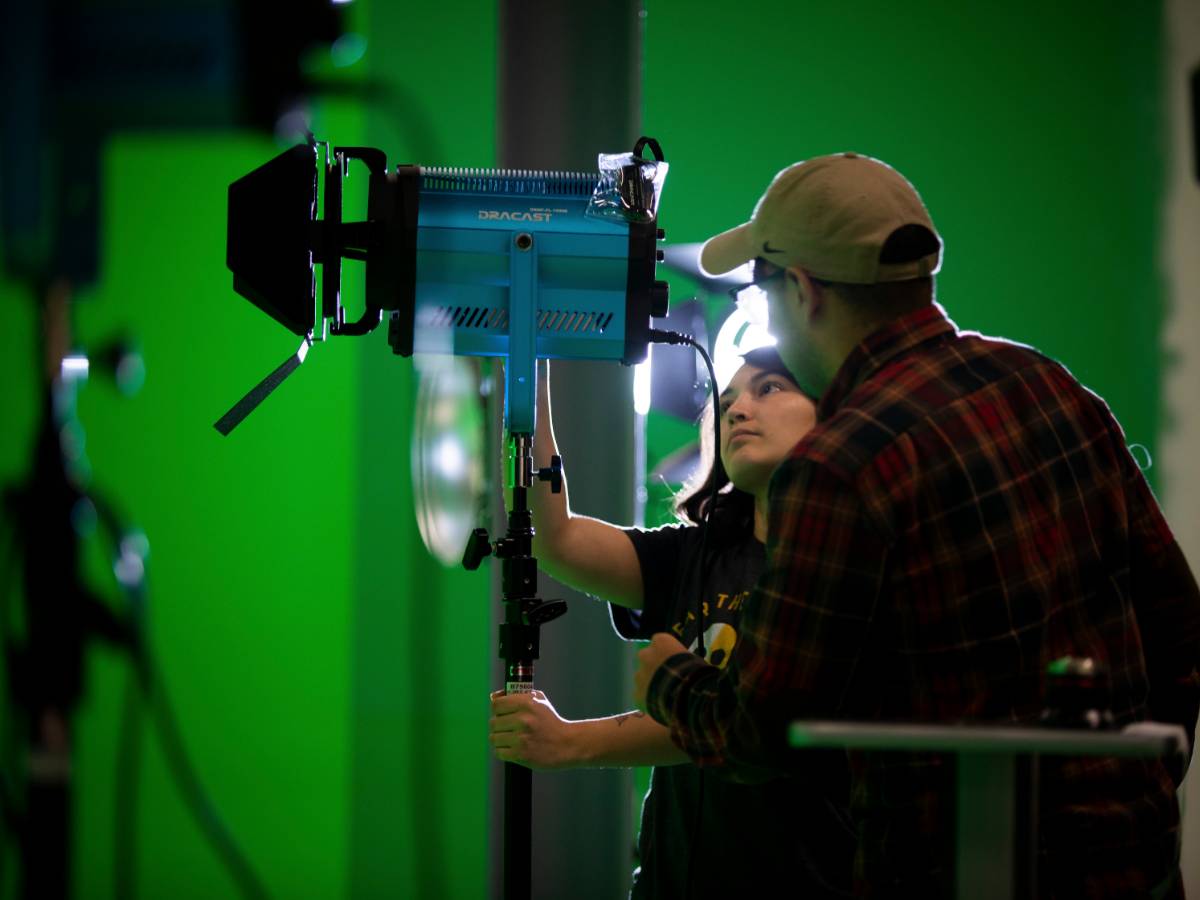 Two student in green screen room.