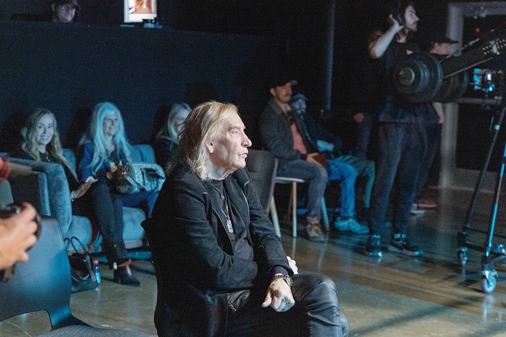 Joe Walsh sitting in a chair.