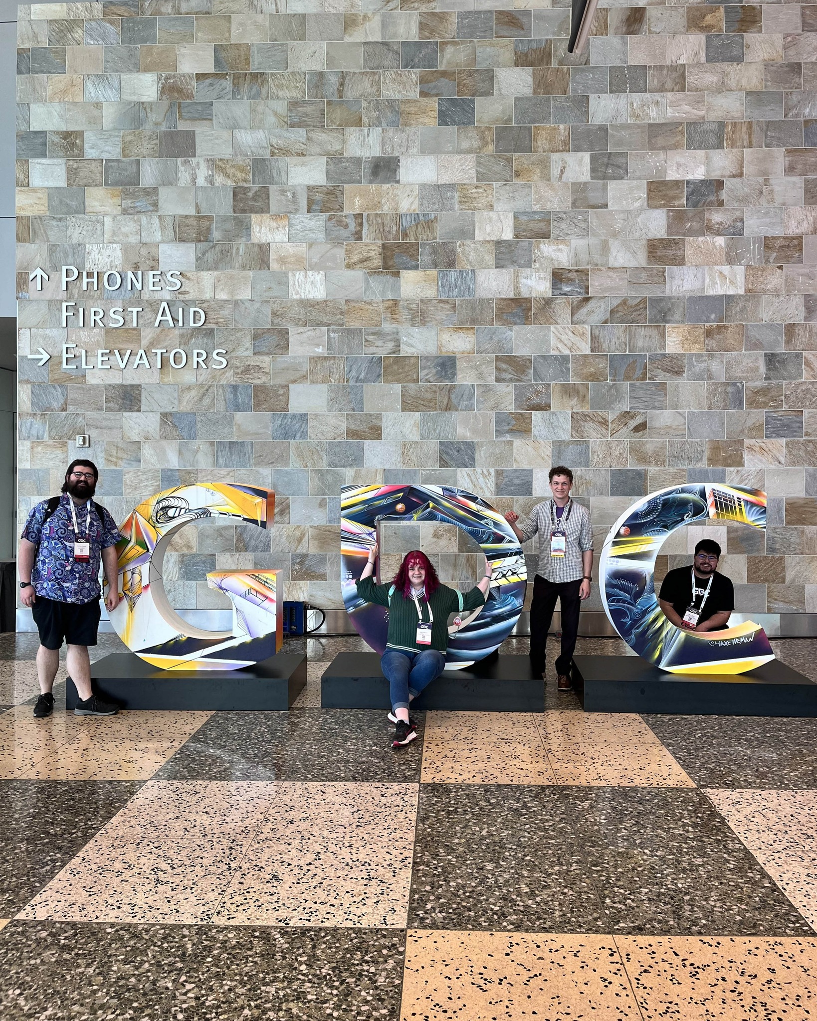 School of Digital Arts students in front of the GDC sign.
