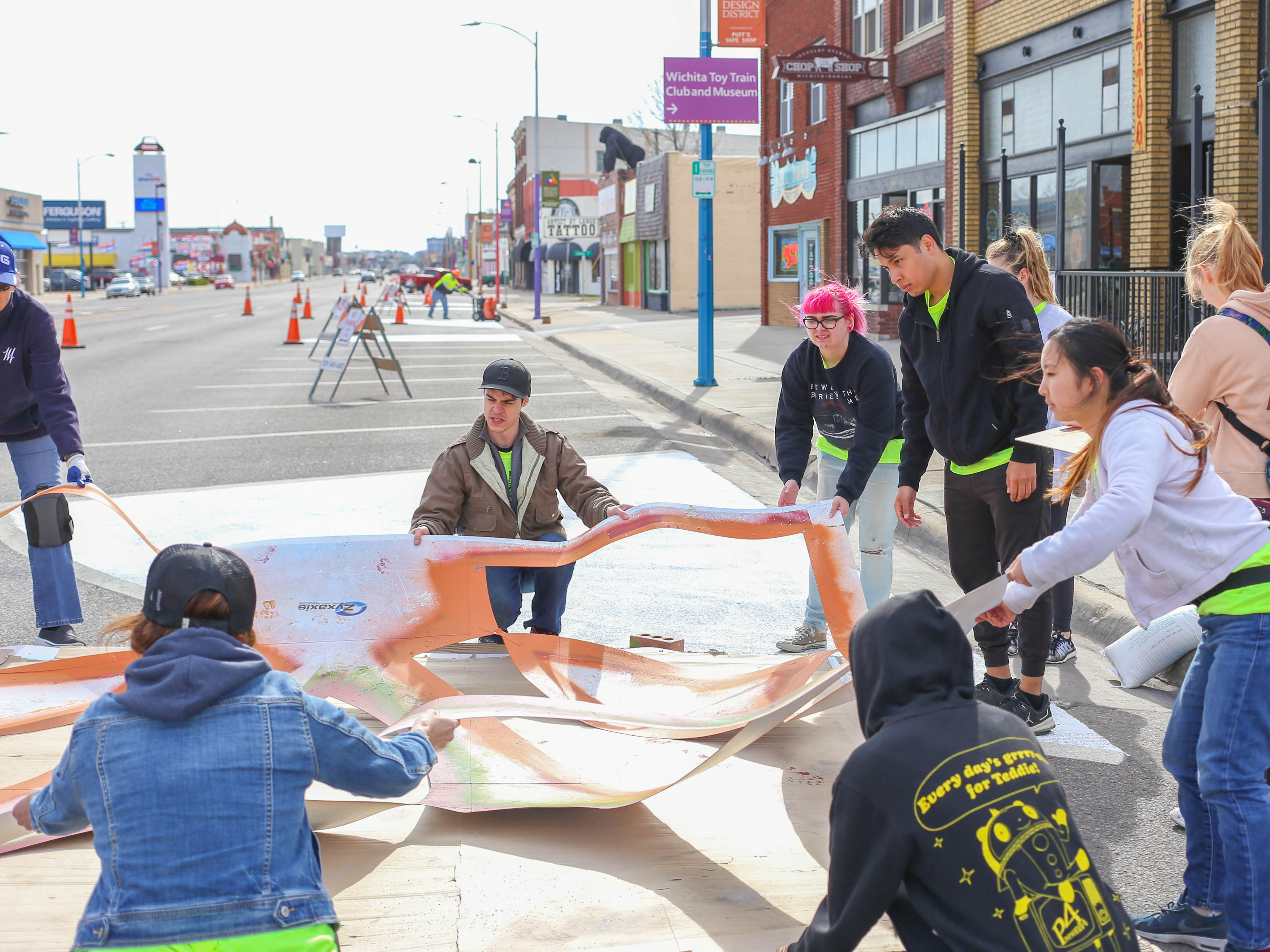 ACDI students working on a mural in Douglass Design District.