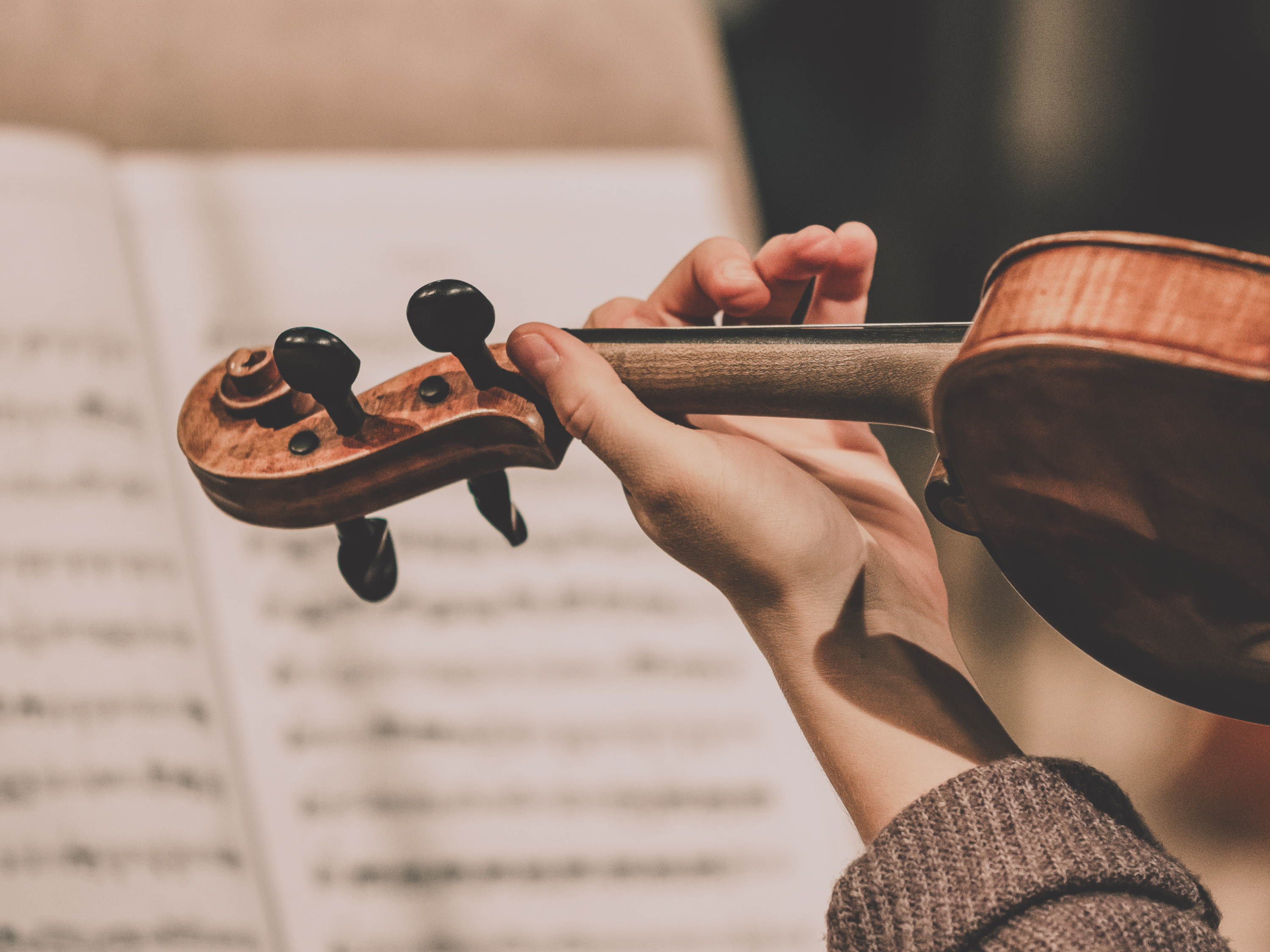 Violin player with music in the background