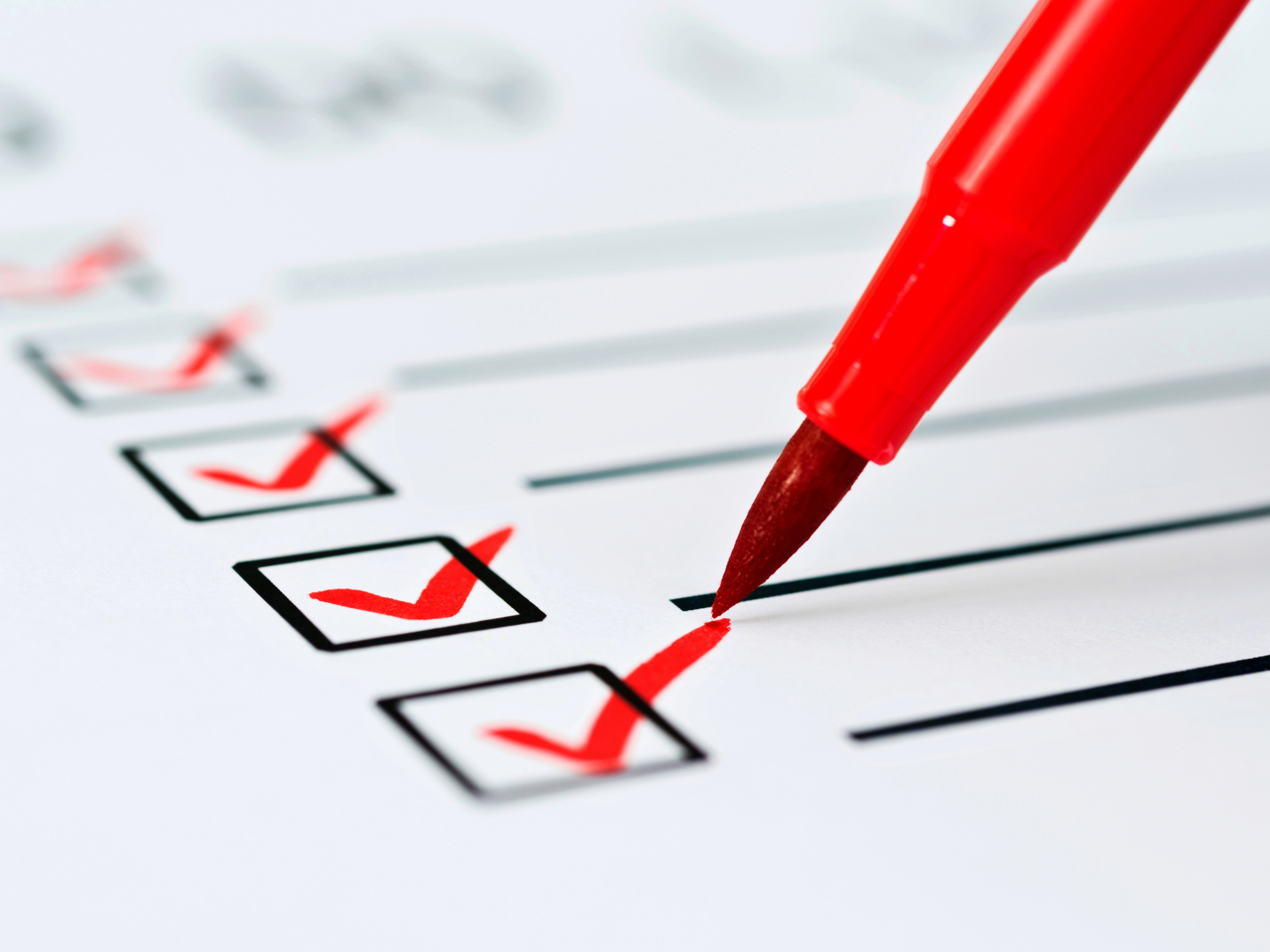 Check list with a red marker and red checkmarks