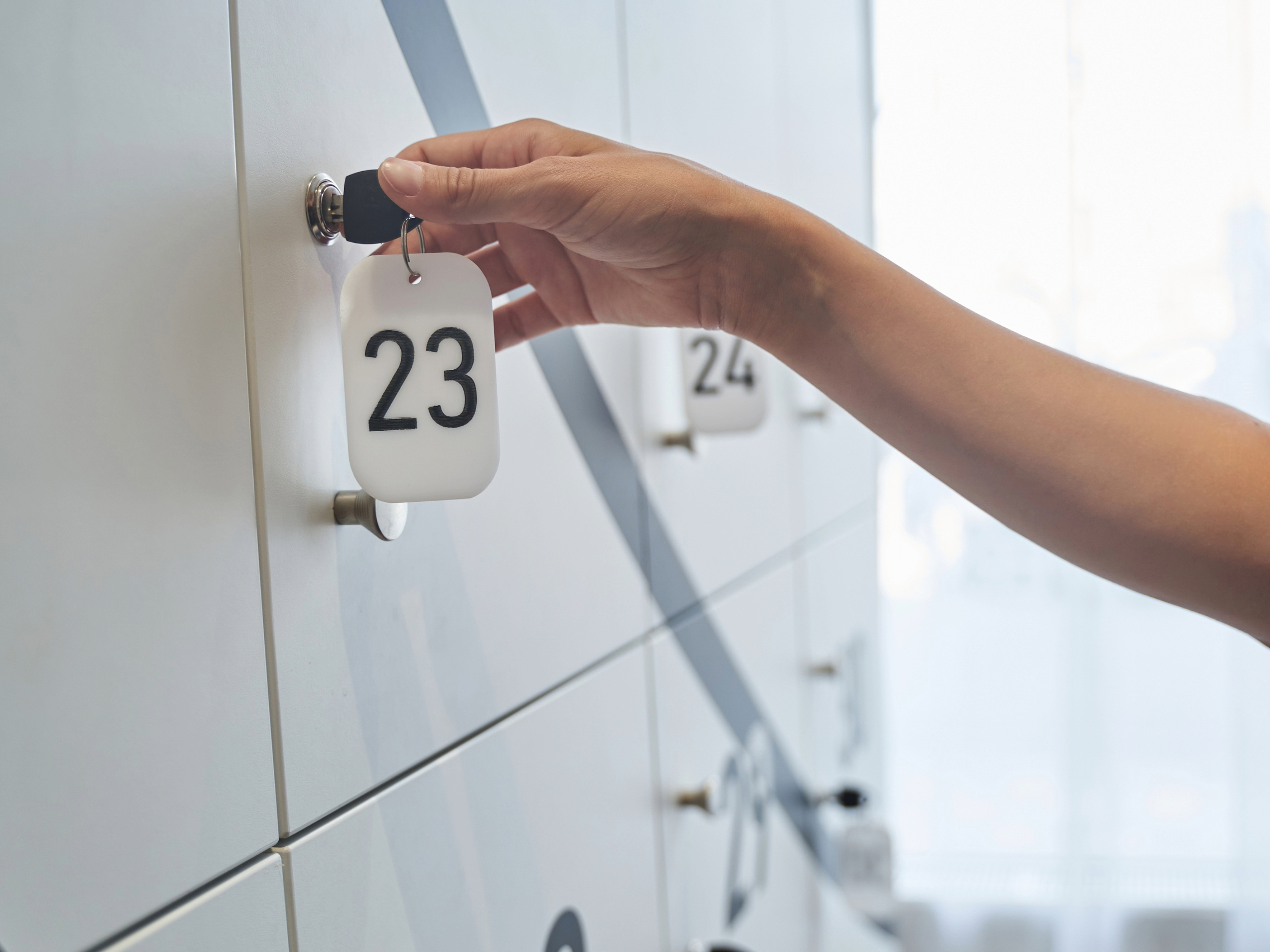 Student with a key at a locker