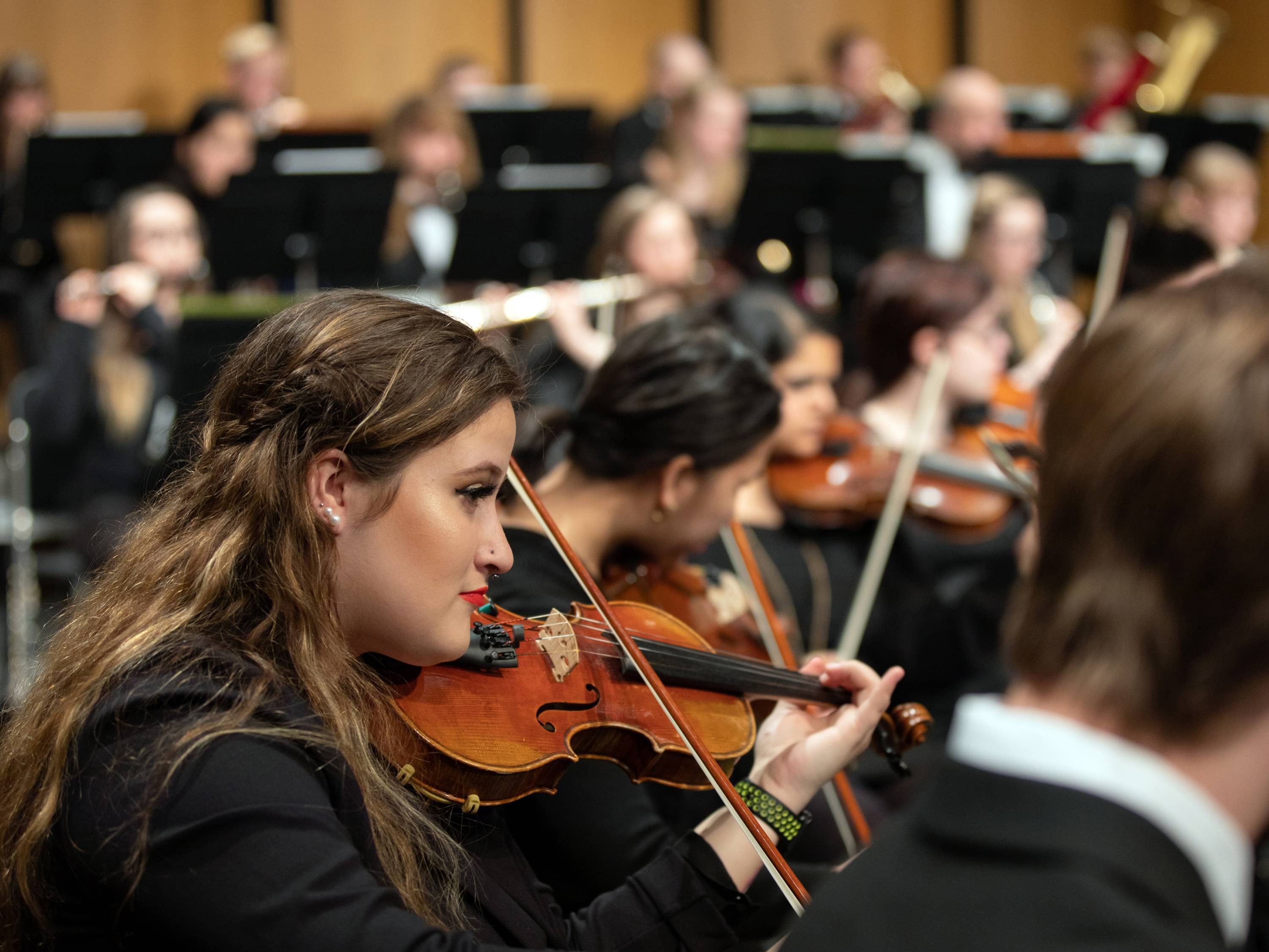 Violin player in orchestra performance