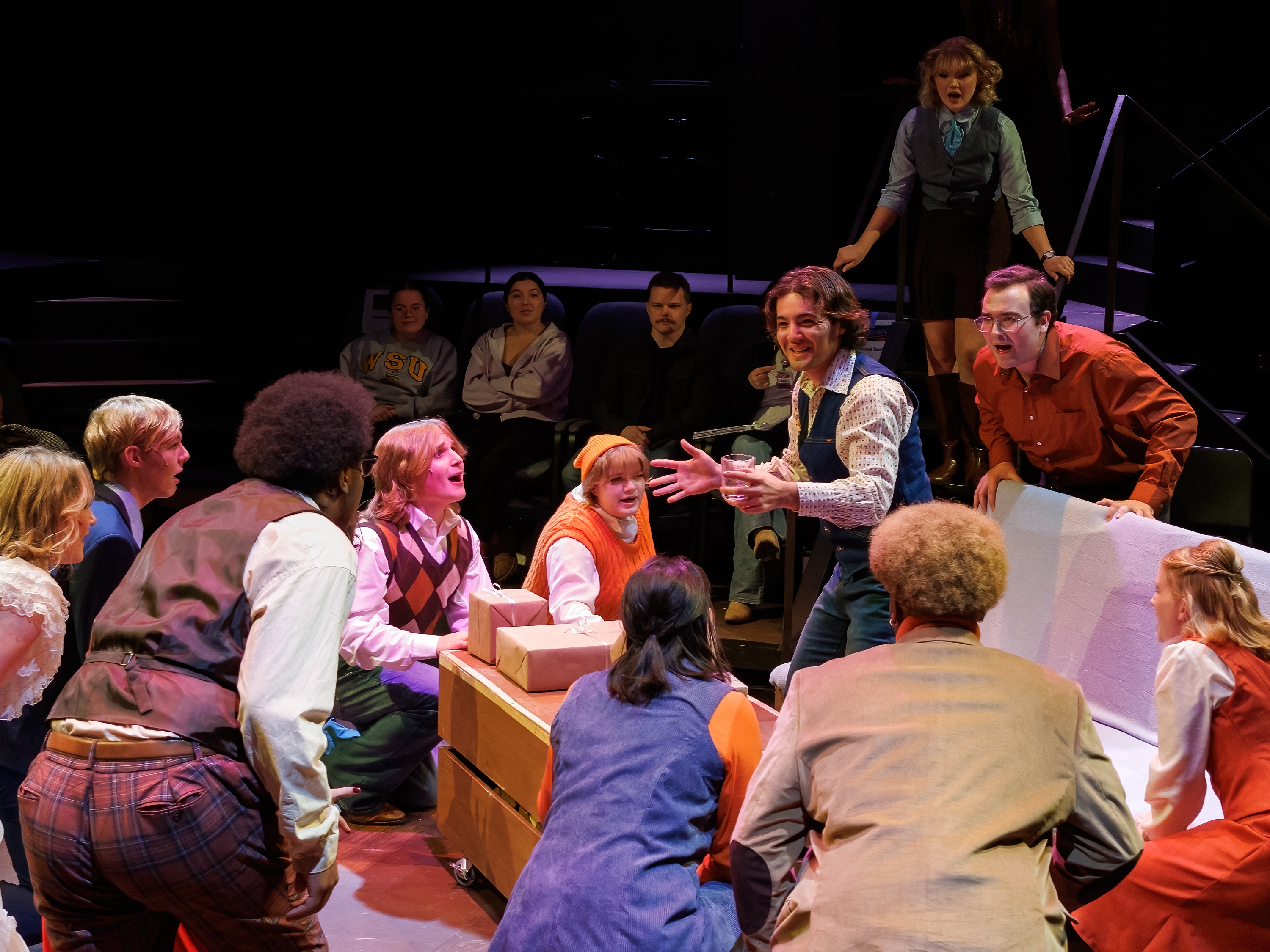 picture from Company where several people are paying attention to the man in the middle
