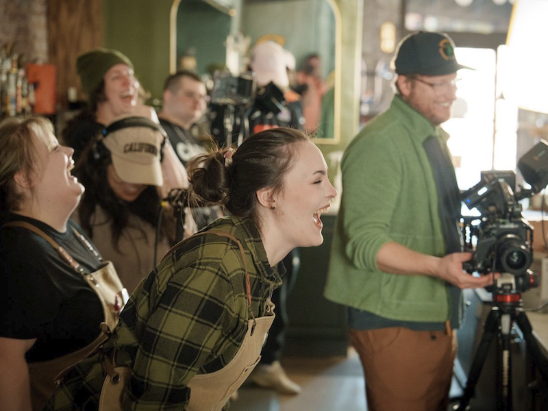 Film students & crew laughing on set while filming