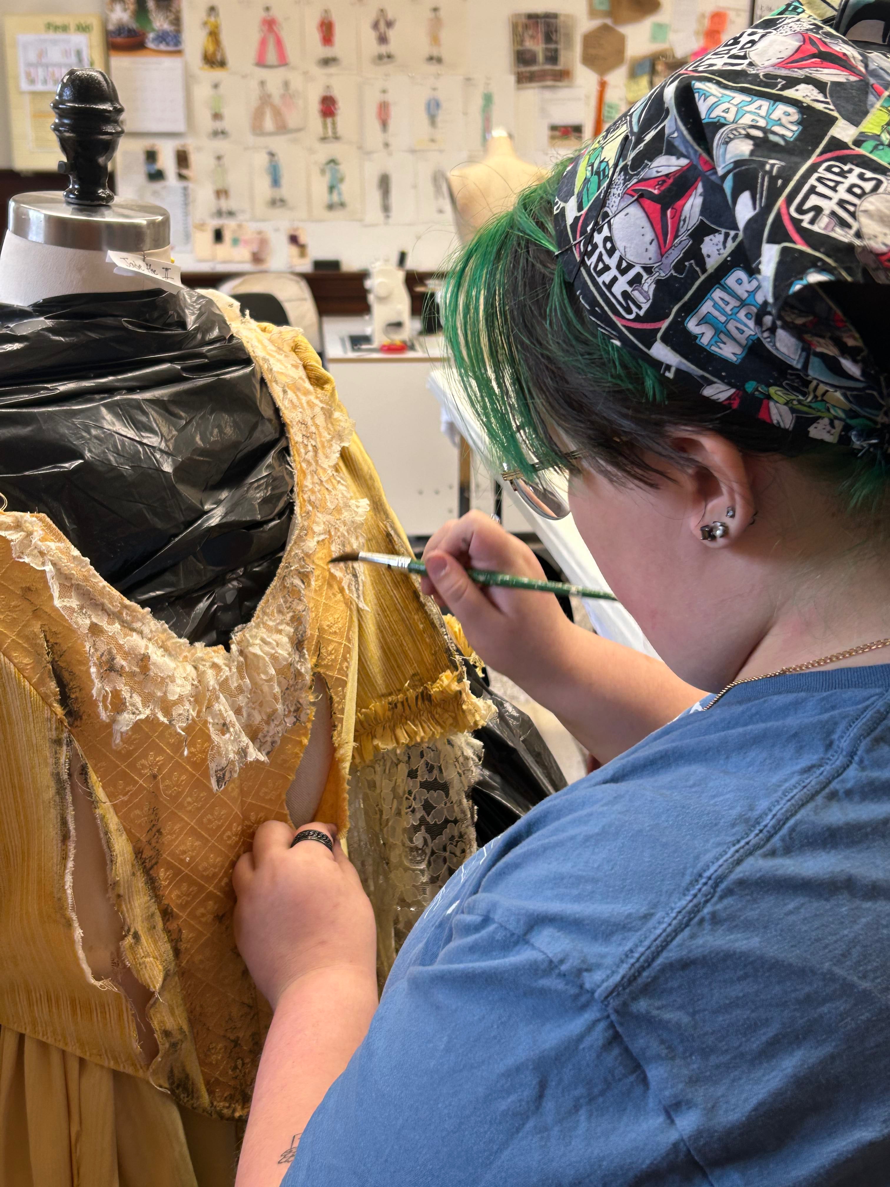 student working on a costume