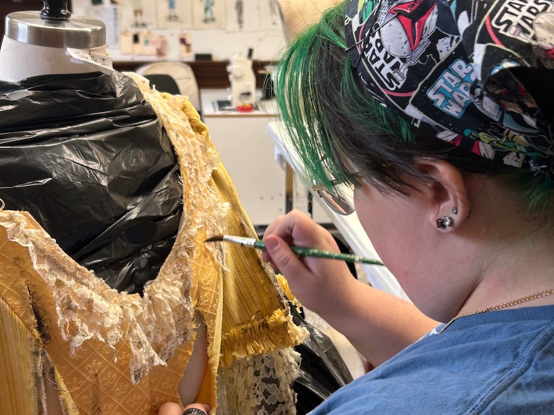 student working on a costume design