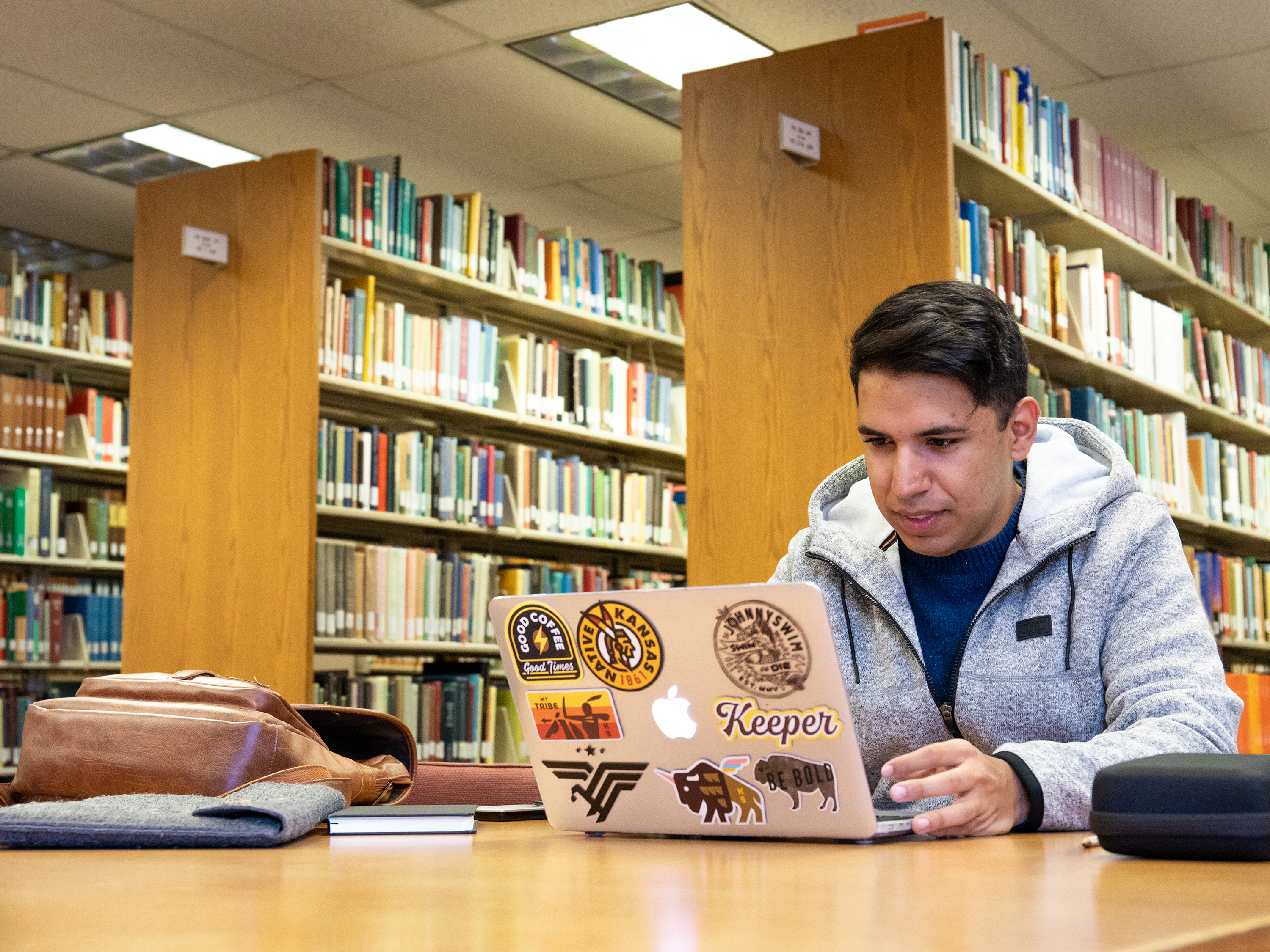 A student works at his laptop in Ablah Library