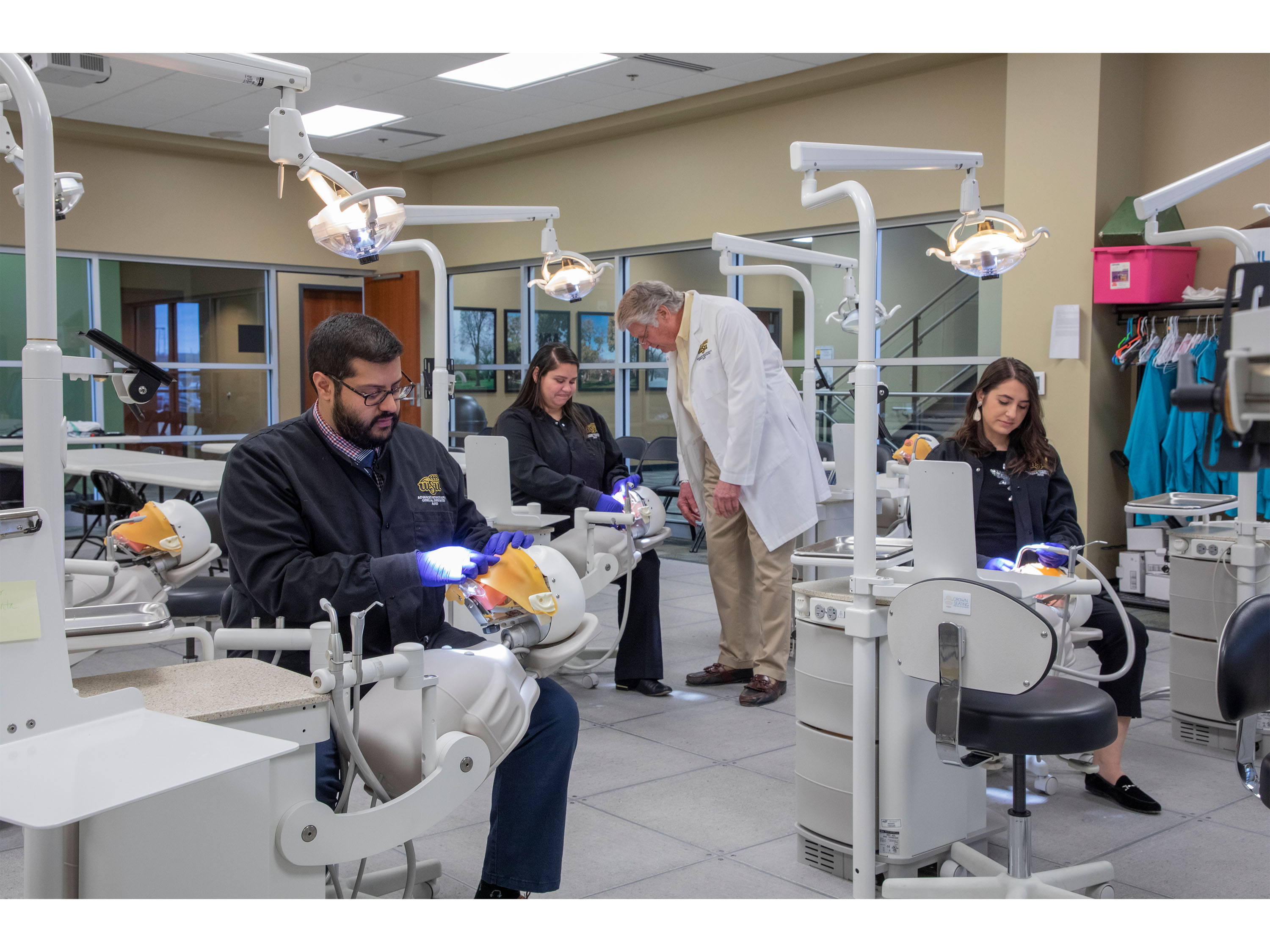 Dental residents and faculty work in simulation lab