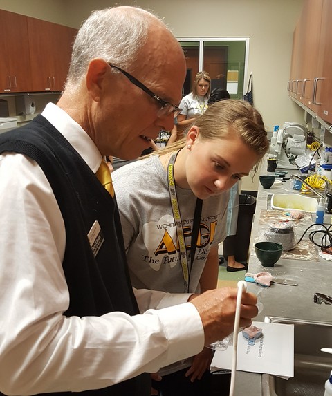 Dean Elledge instructing student at Dental Camp