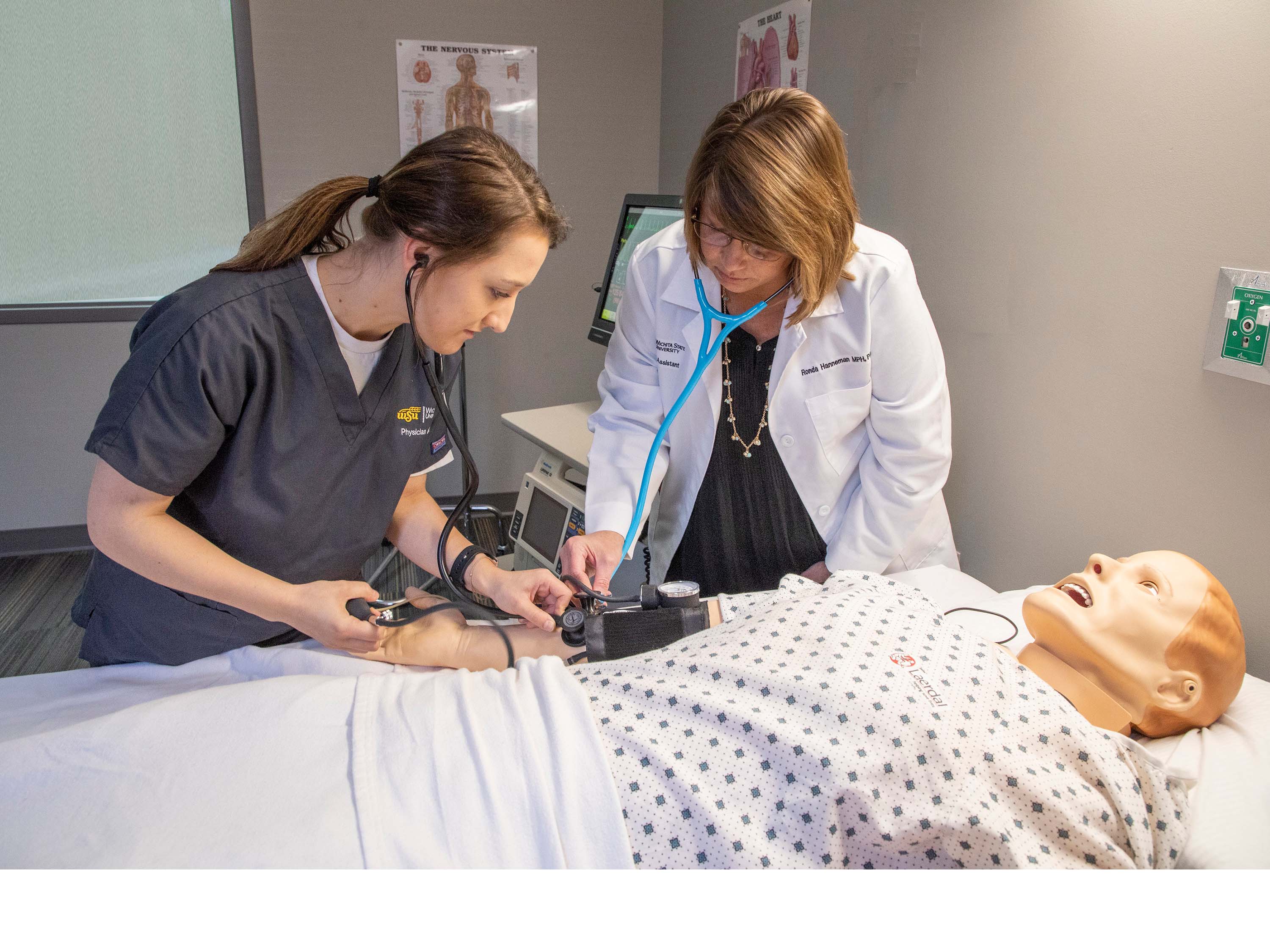 Student and faculty examining mannequin