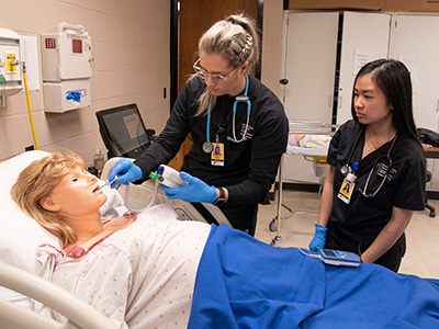 nursing students work on manikin