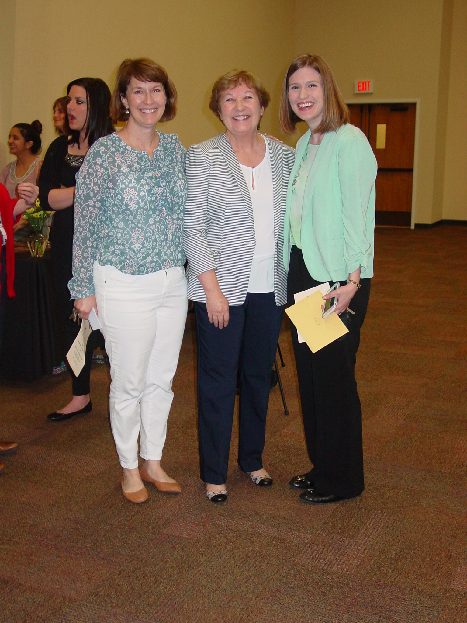 Kathy Strattman posing for a group photo at the retirement reception. 