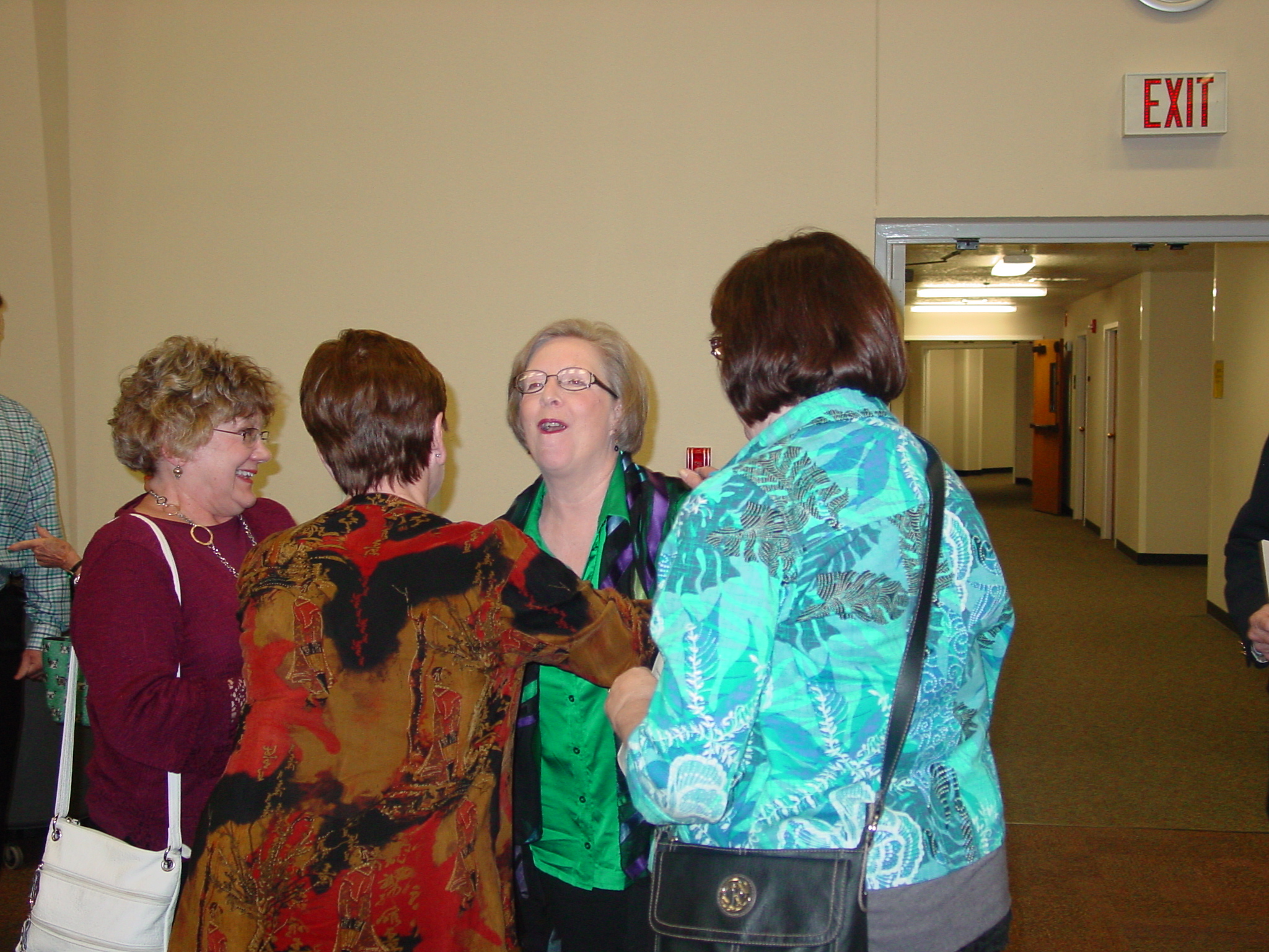 Guest laugh together in group at retirement reception. 