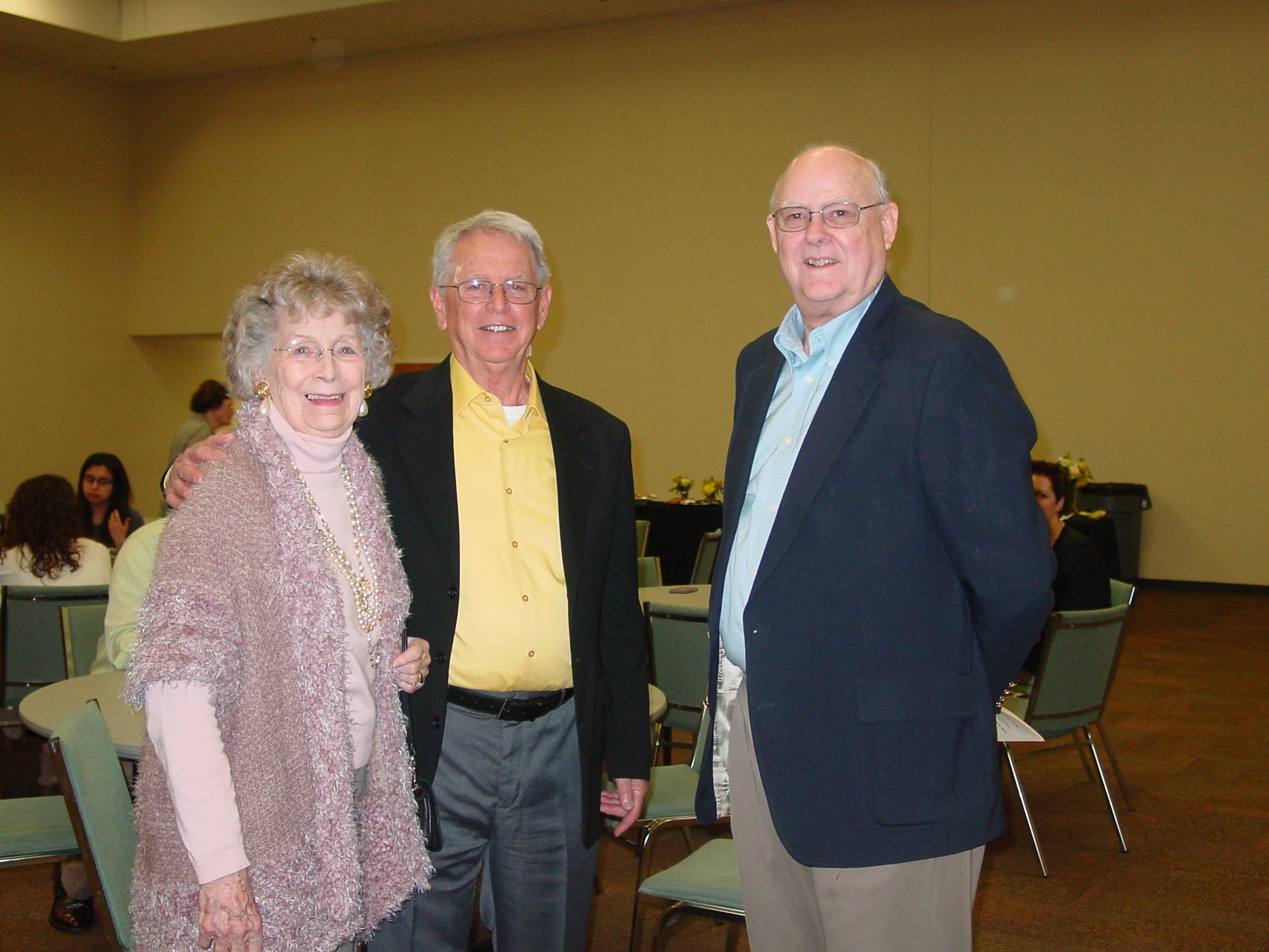 Three guest group photo at retirement reception. 