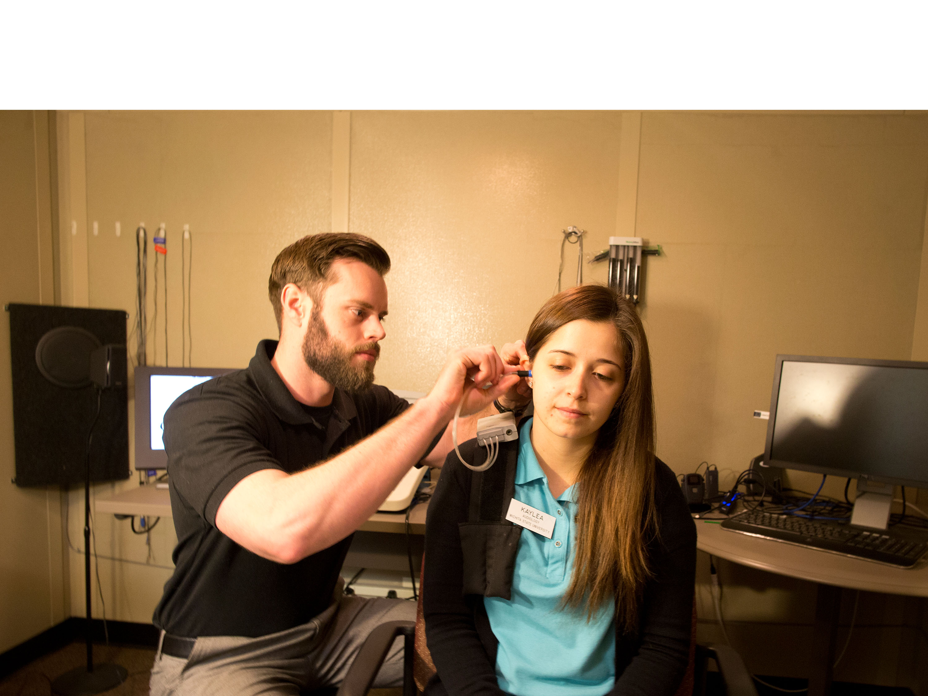 Speech-Language Pathology student working on hearing equipment