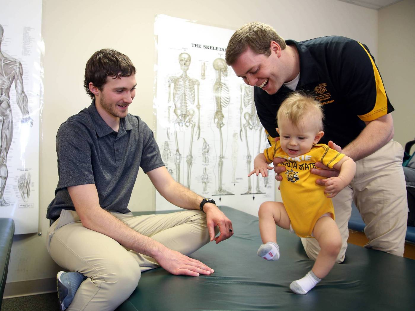 Physical therapy students with baby on baby day