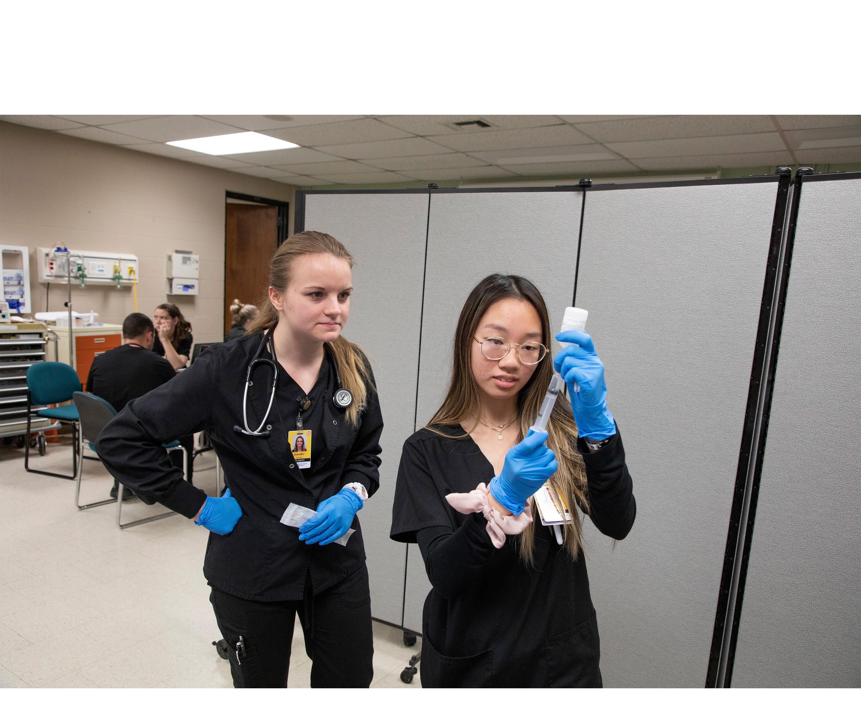 Nursing students work at laptop