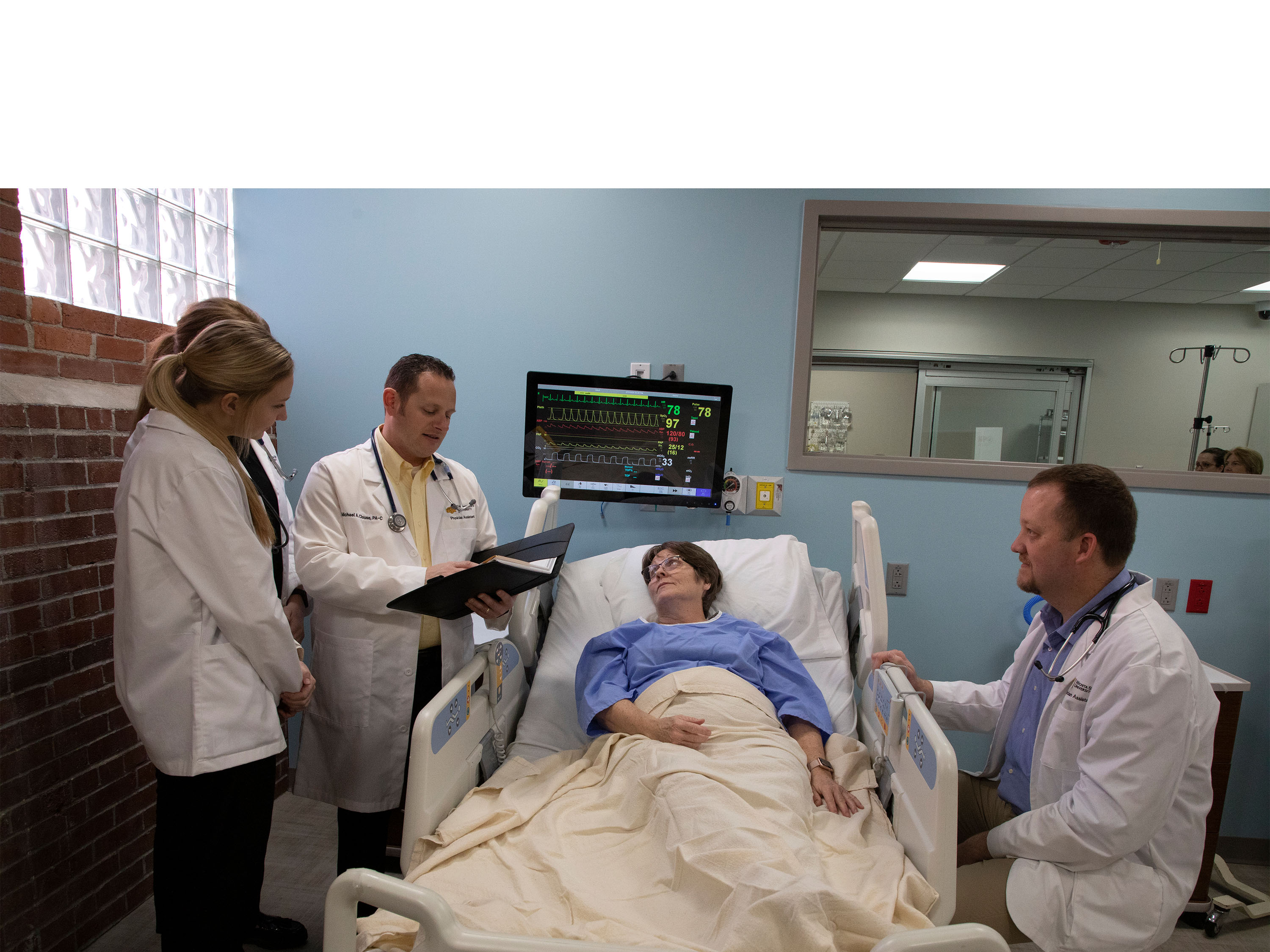 PA faculty and students with patient