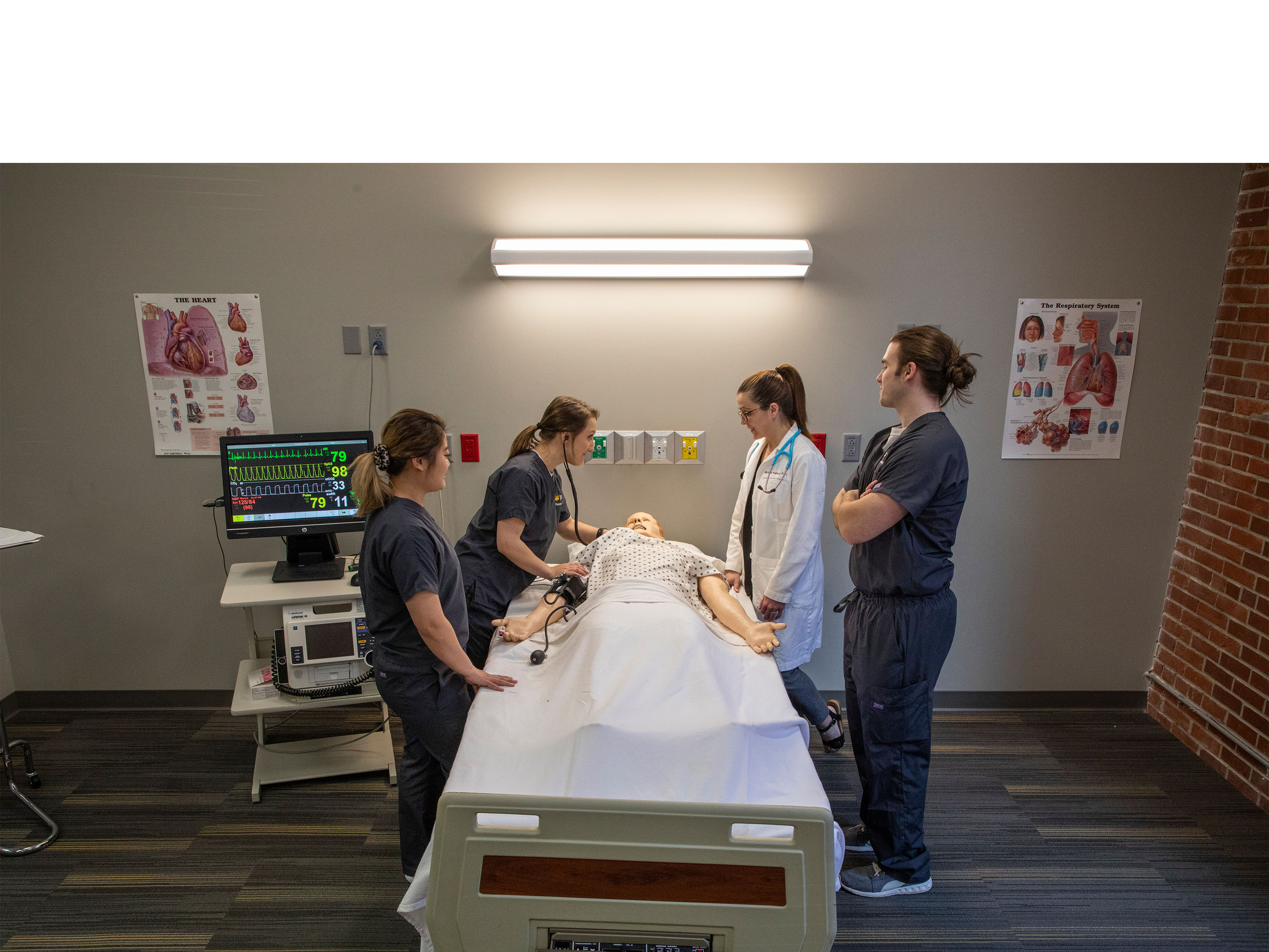 PA students and faculty work on mannequin