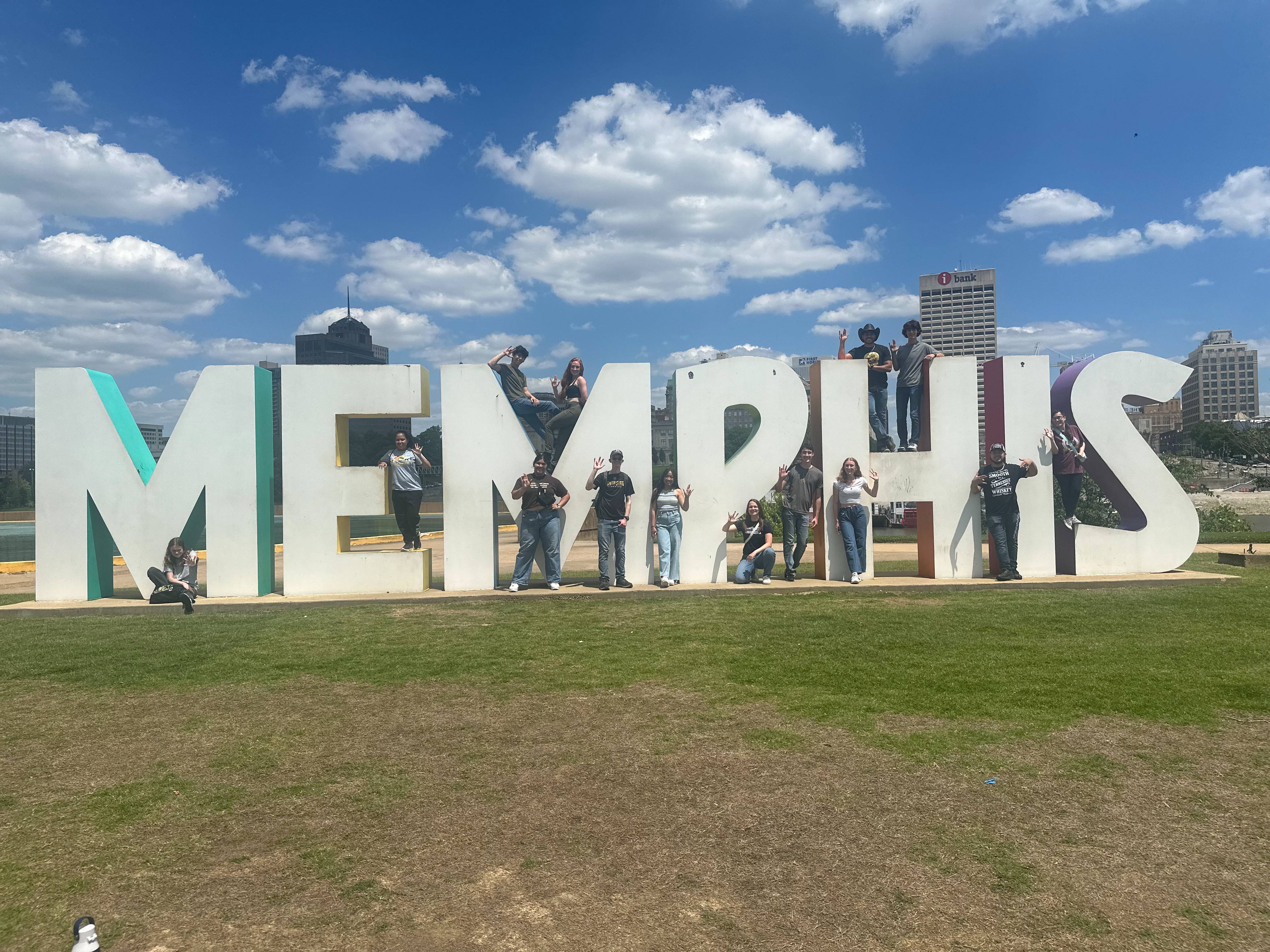Students in front of the MEMPHIS sign