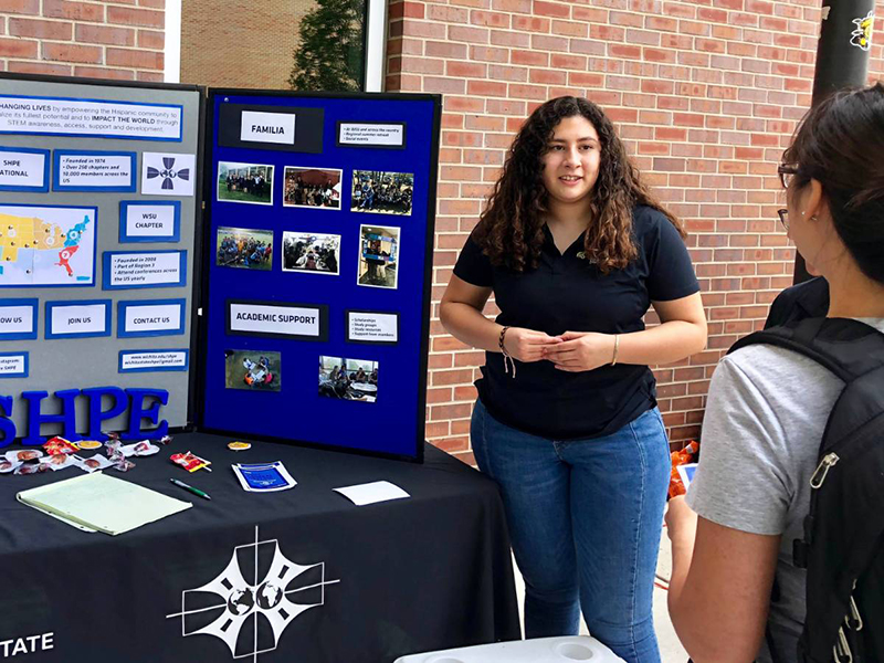 Melissa Rocha, a biomedical engineering major and officer in Society of Hispanic Professional Engineers, tries to get fellow students to join at Engineering Block Party held the first week of school.