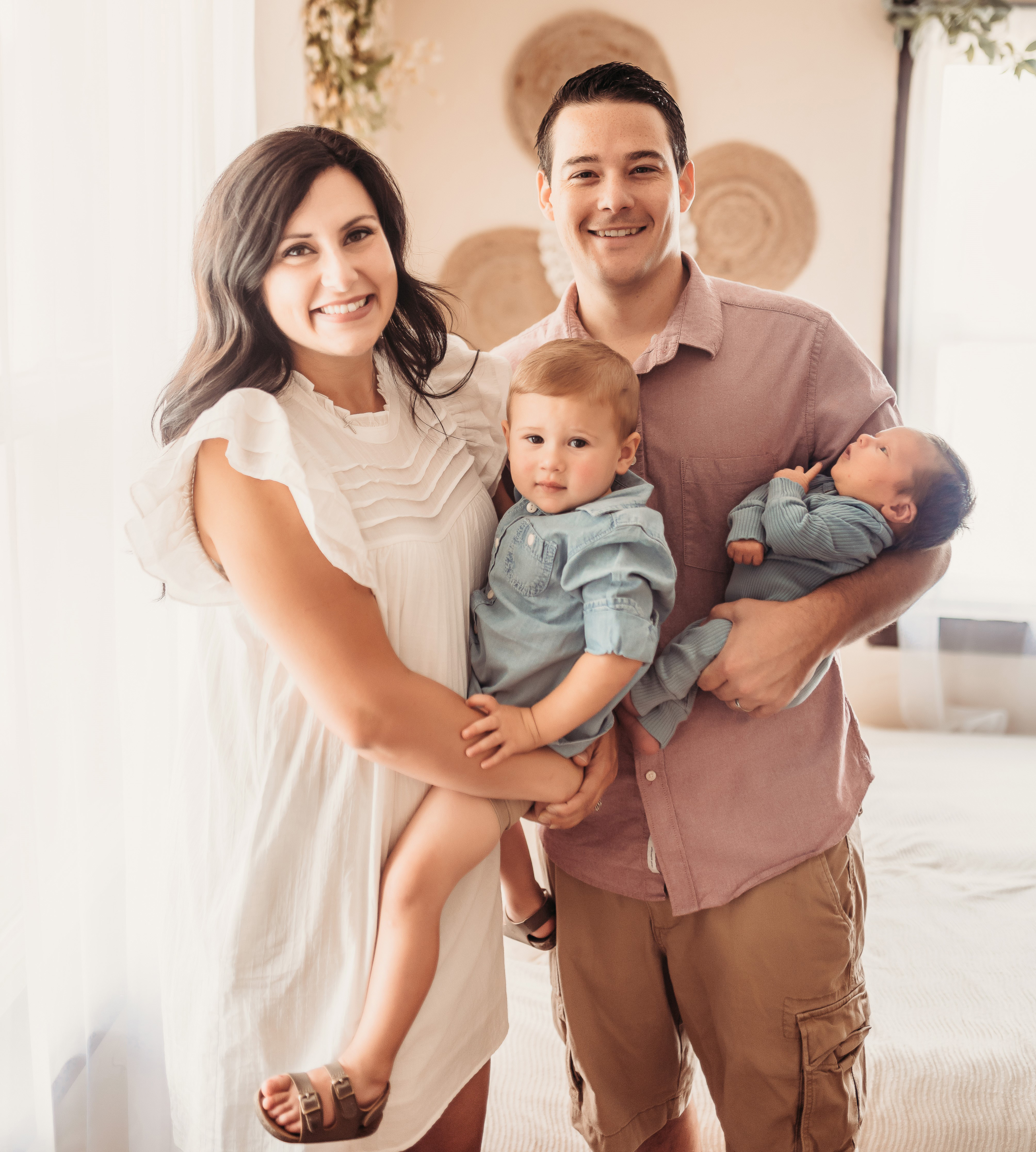 Mandy and Bryce Moral holding their two kids.