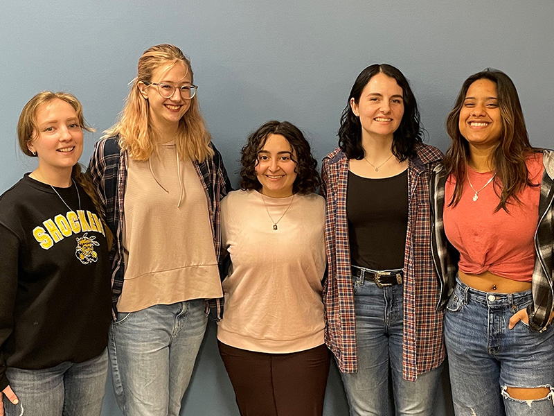 The team behind XX Menstrual Monitoring standing in front of a blue background.
