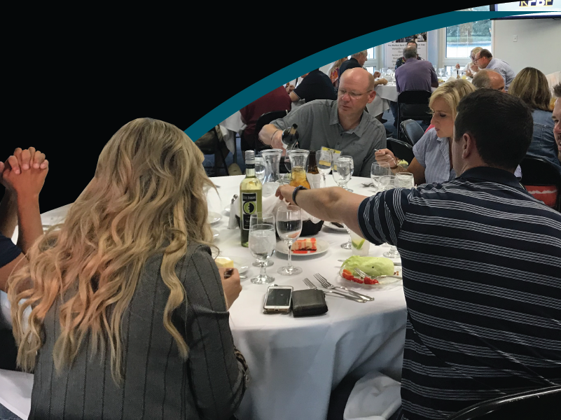Members of family owned businesses eating a meal together