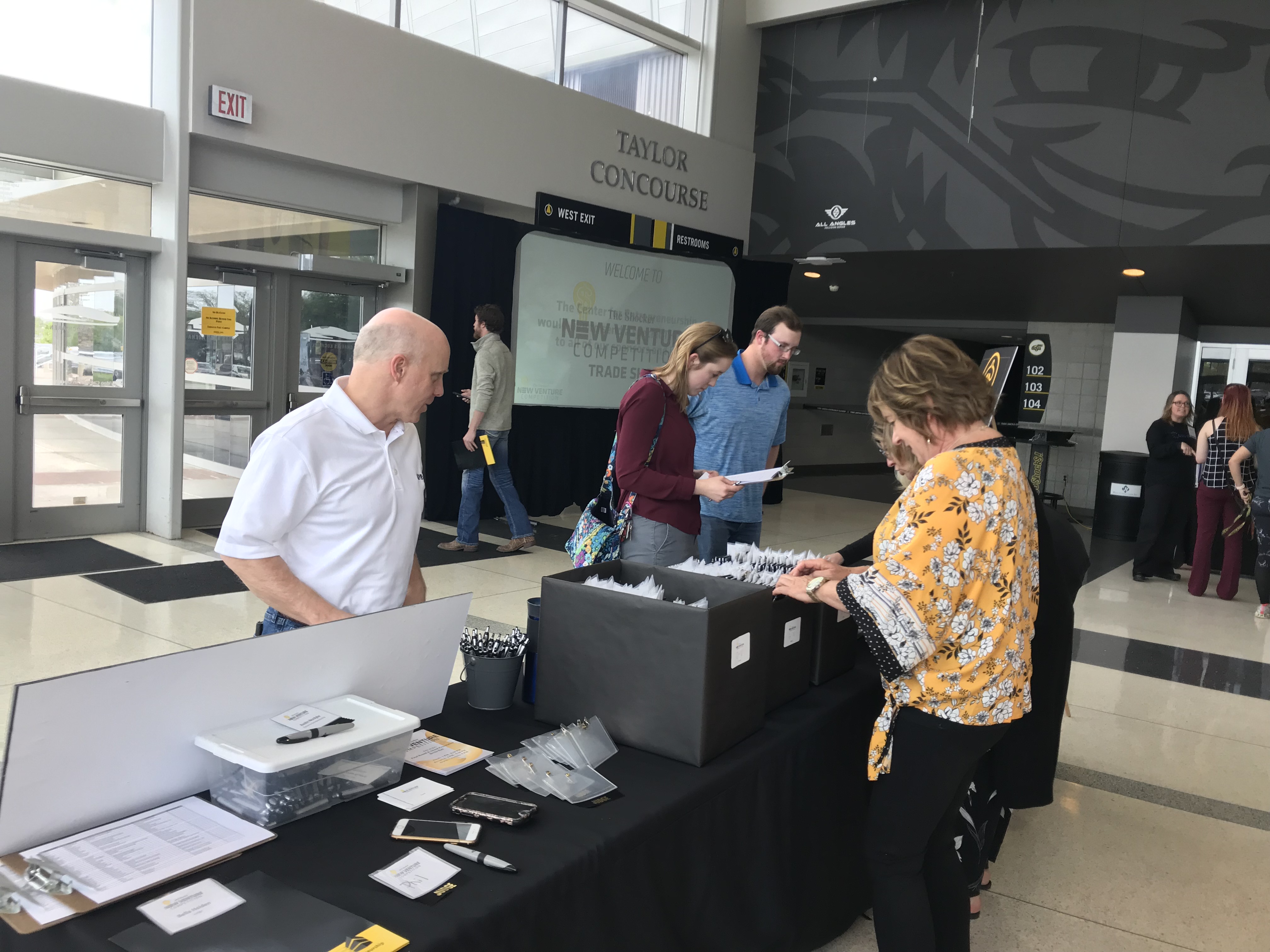 volunteers running the registration table at the trade show