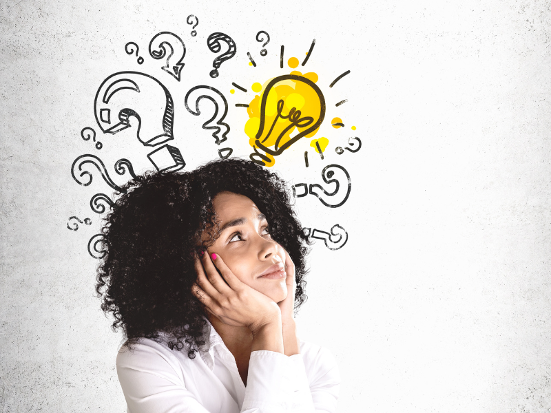 Woman looking up with questionmarks and a lightbulb overhead.