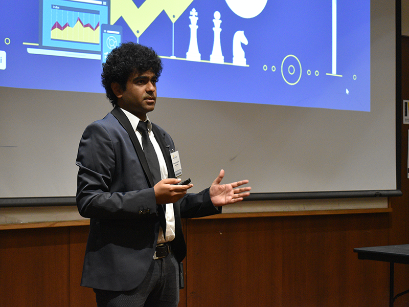 Student entrepreneur standing in front of their pitch deck as they pitch at the Finals