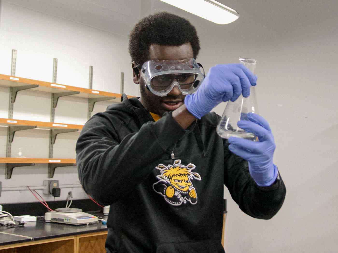 Student measuring a fluid.