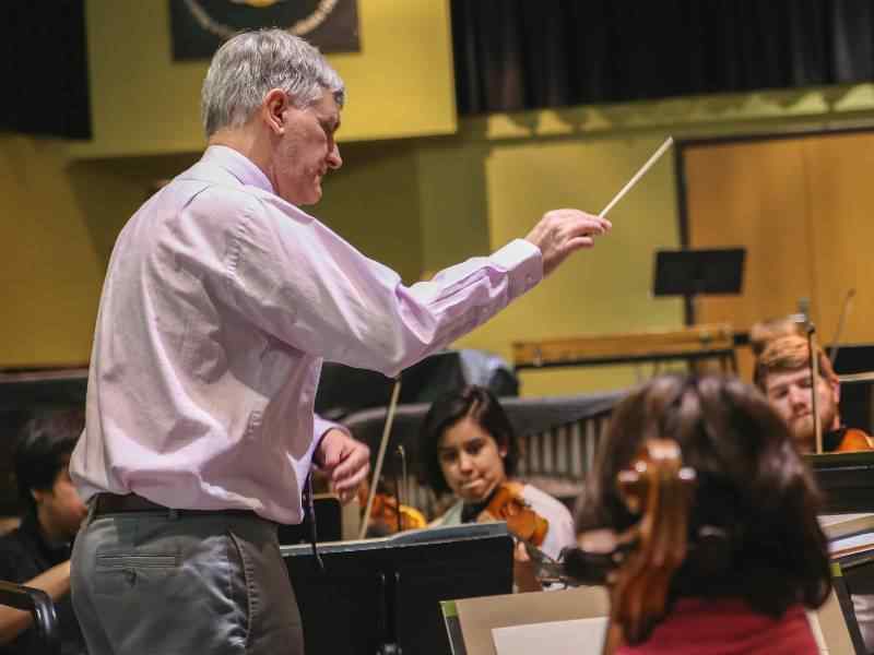 Professor conducting music.