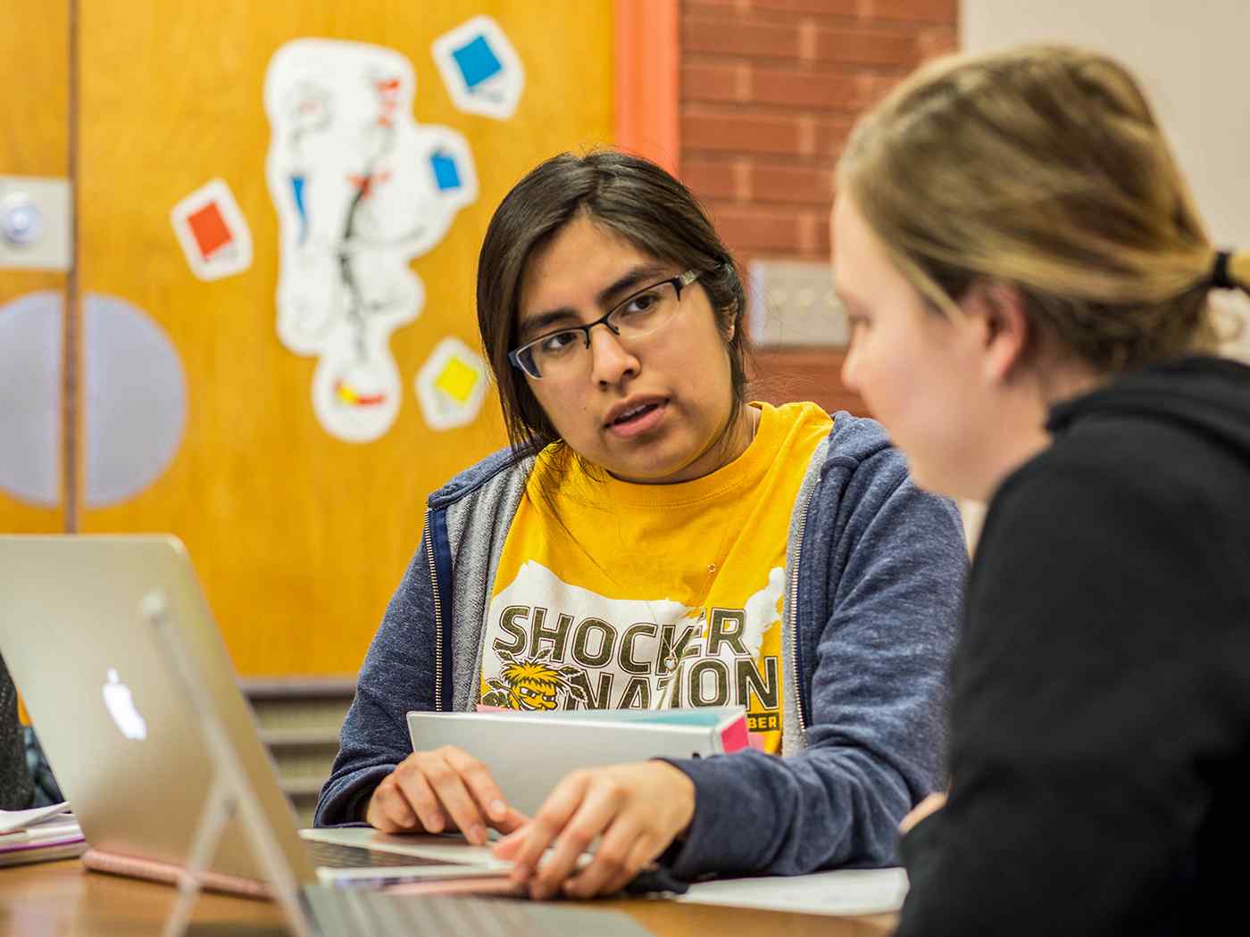 Two female Marketing Communications students studying. 