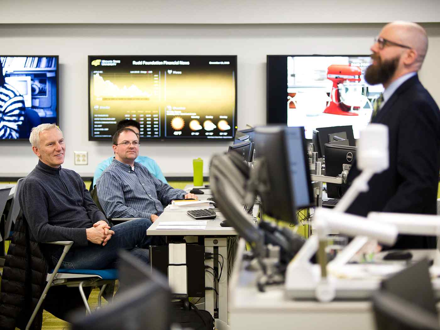 Graduate students listening to a lecture in Koch Trading Center.