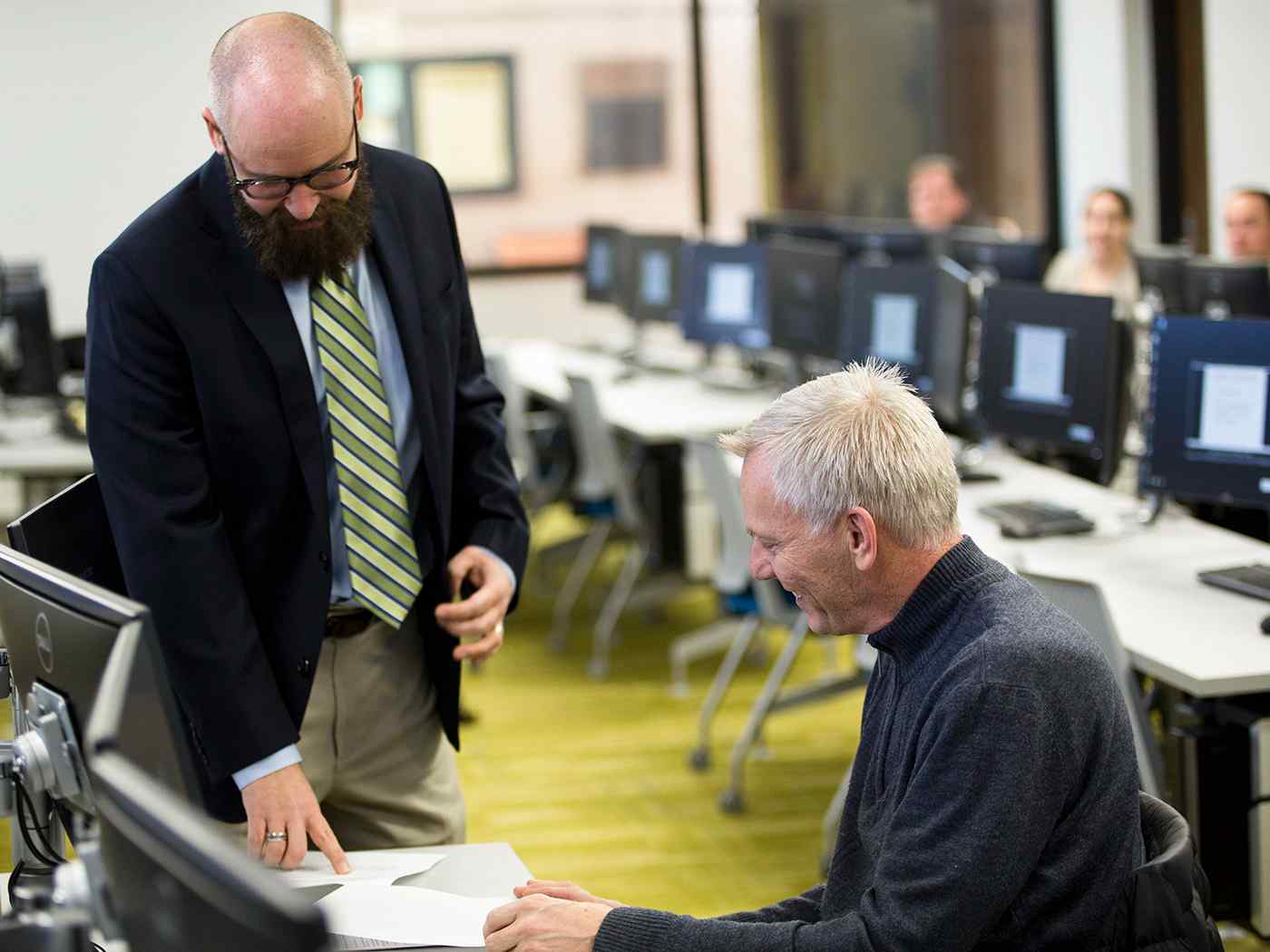 Dr. Craft talking to older male EMBA student.