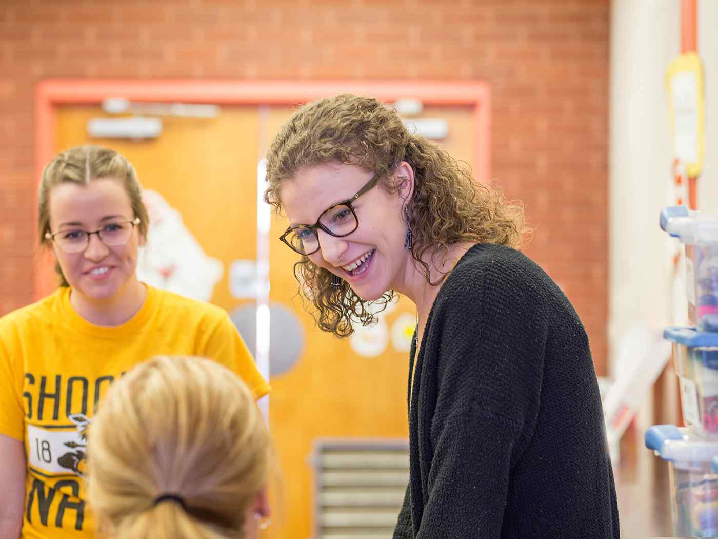 Education students chatting in classroom in Corbin Hall.