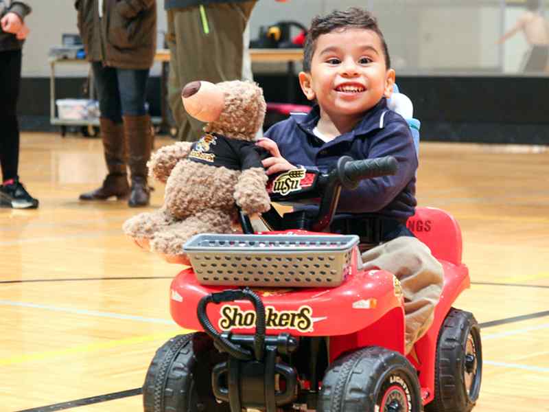Students help modify cars for children with disabilities.