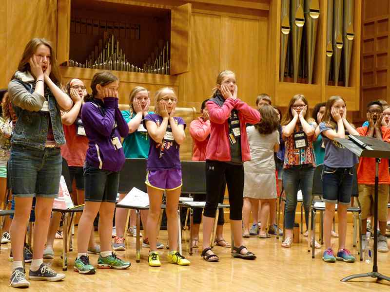 Children practice the Kodaly method of singing.