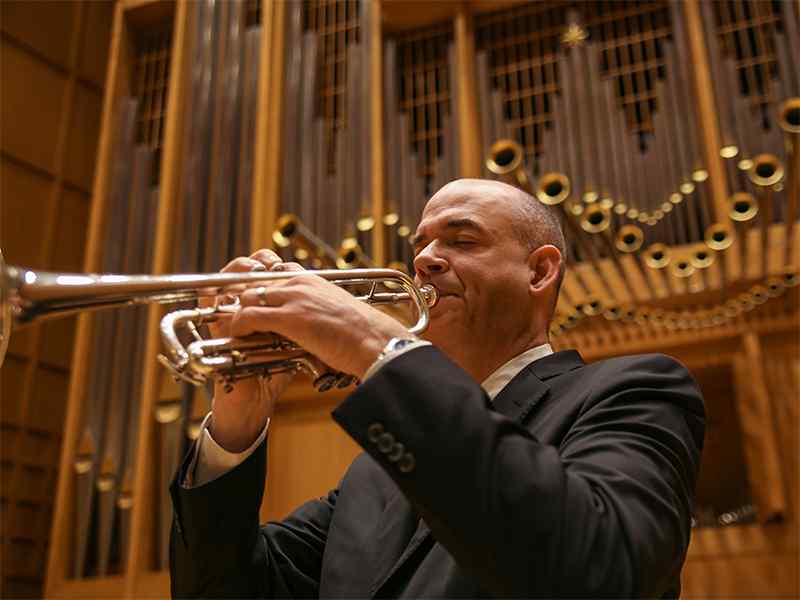 David Hunsicker is a trumpet professor who invented a device to make it easier to play the trumpet.