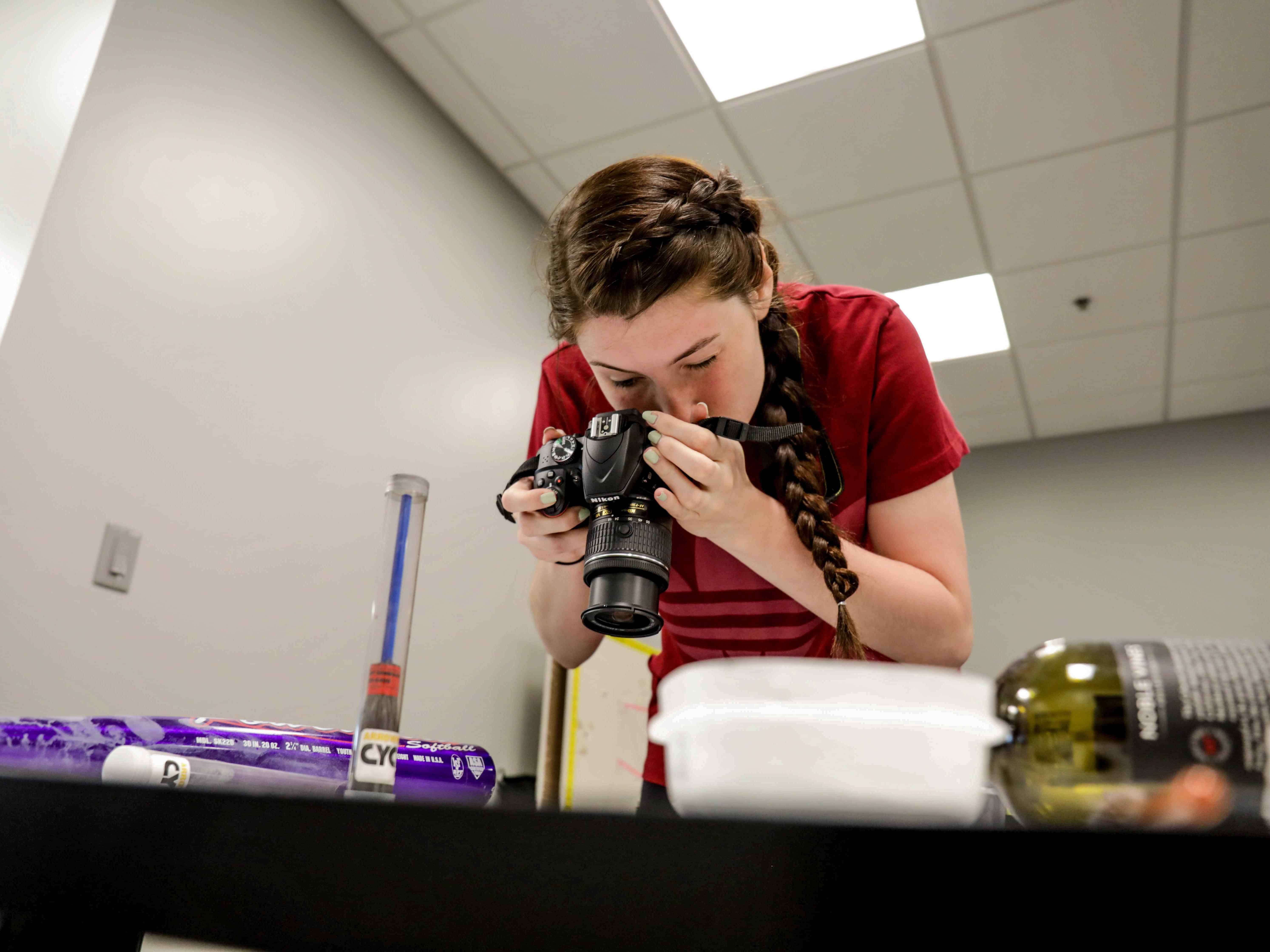 A student photographs evidence samples