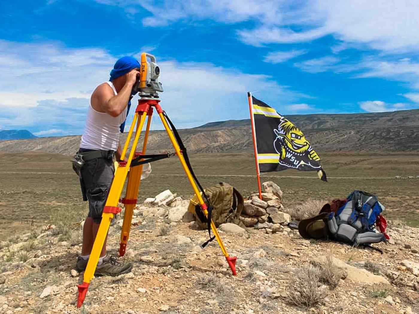 Students out in the field measuring.