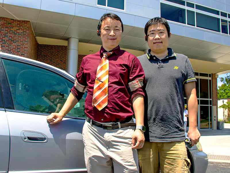 Jibo He, left, and student Long Wang work on a device to detect driver drowsiness.