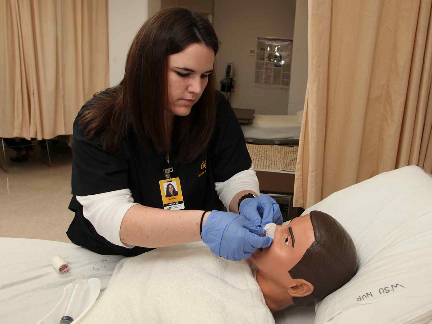 Student nurse caring for her patient