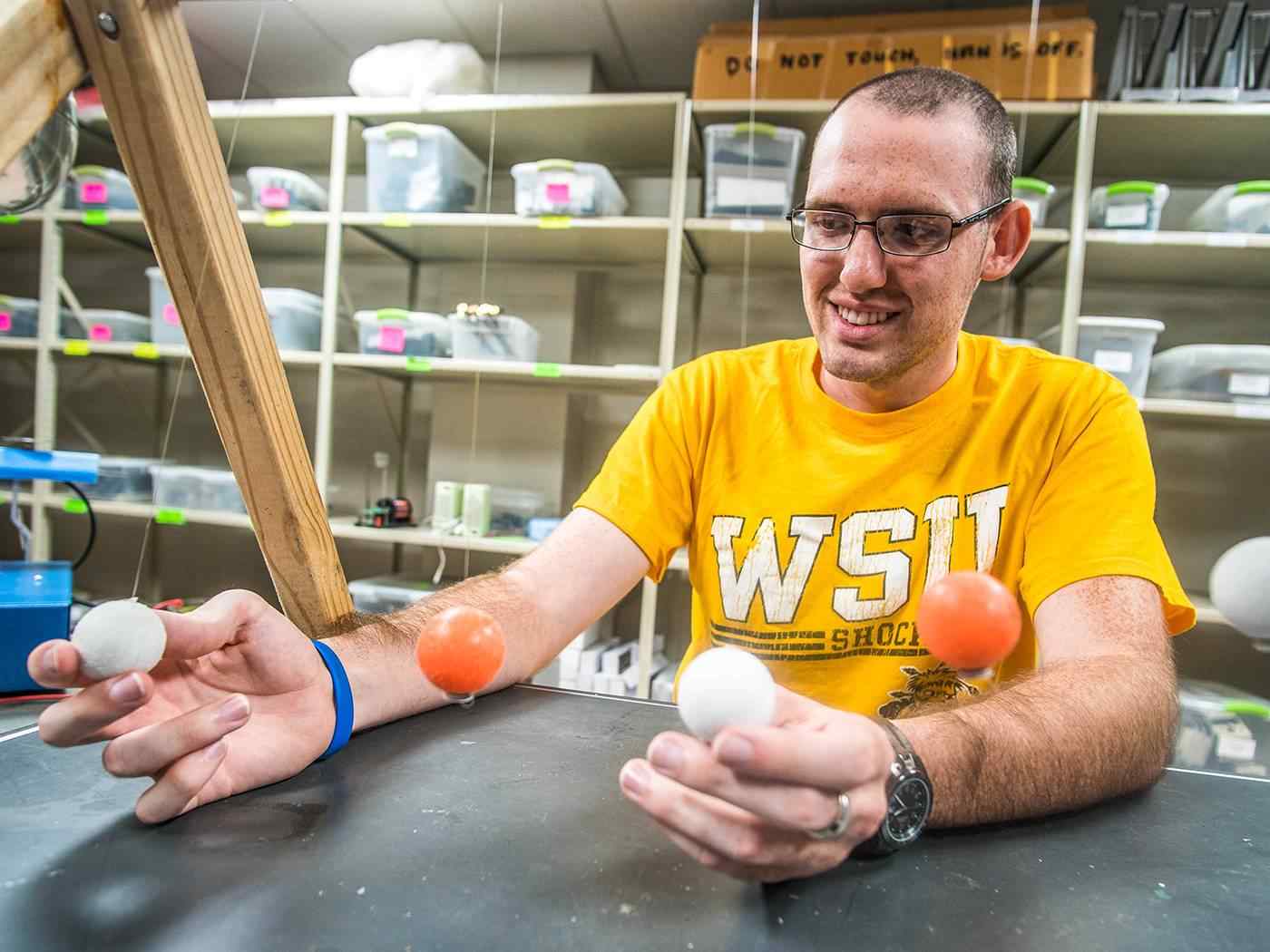 Student performing a physics experiment.