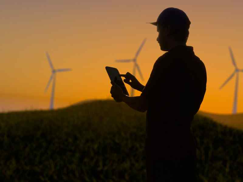 Student working on site at a wind energy farm