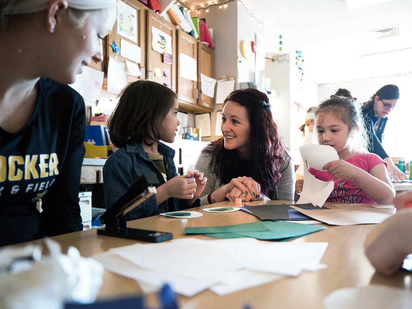 Female para educators with children.