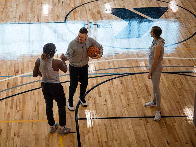 Students playing a game of basketball at the Y